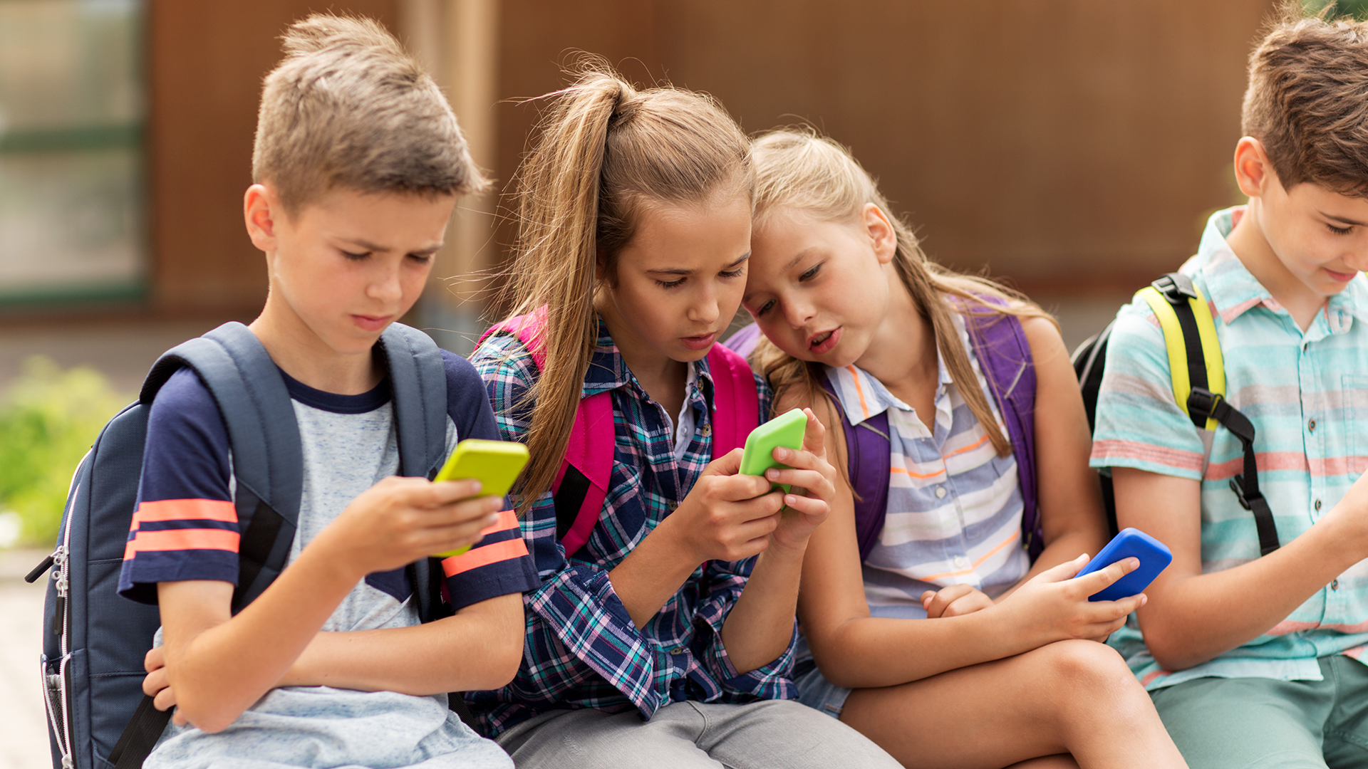 elementary school students with smartphones